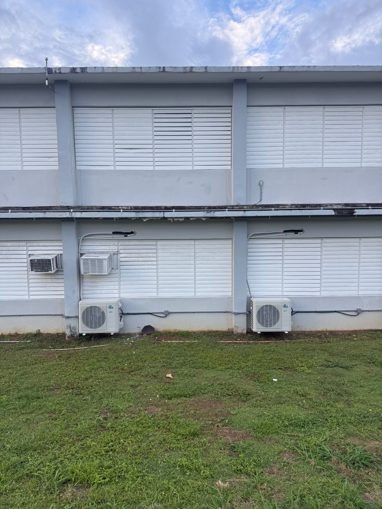 Unidad exterior de aire acondicionado instalada en un espacio comercial